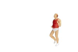 Miniature person running isolated on a white background photo