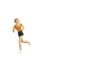 Miniature person running isolated on a white background photo