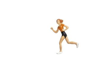 Miniature person running isolated on a white background photo