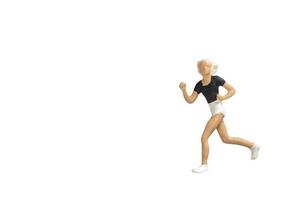 Miniature person running isolated on a white background photo