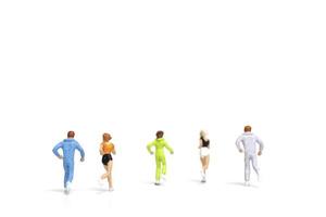 Miniature people running isolated on a white background photo