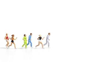 Miniature people running isolated on a white background photo