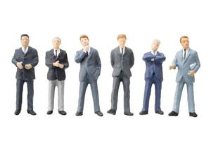 Miniature businessmen on a white background photo