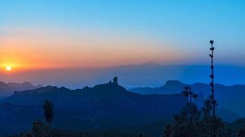 Sunset in the mountains of Gran Canaria with Mount Teide in the background photo
