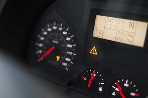 Capital T and steering wheel warning lit on vehicle display of a heavy truck photo