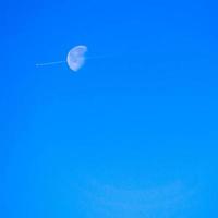 Jet smoke over moon photo