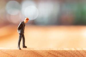 Miniature businessman standing and thinking with a colorful background photo