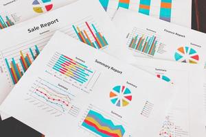 Financial graphs and charts on a wooden table photo