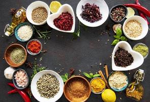 Various spices in a bowls on a black concrete background photo