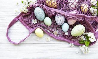 String bag with Easter eggs and spring blossom photo