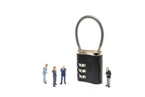 Miniature businessmen helping to unlock the password on a lock, business solution concept photo