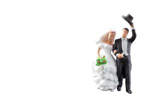 Boda en miniatura, la novia y el novio aislado sobre un fondo blanco. foto