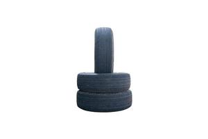 One vertical car tire stacked on two horizontal tires isolated on a white background photo