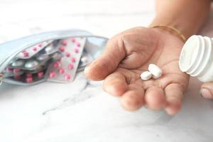 Elderly women taking medicine photo