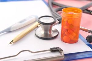 Stethoscope and pills container photo