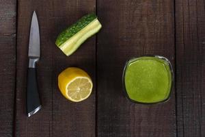 Cucumber smoothie on brown table photo