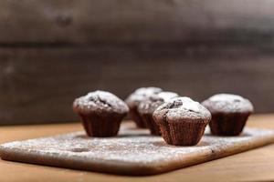Chocolate muffins on the wood board photo