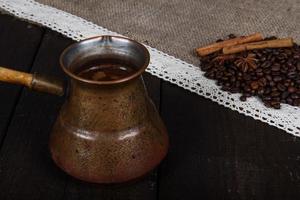 Black coffee with grains and cinnamon photo