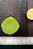 Cucumber smoothie on brown table photo