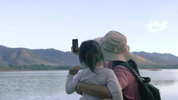 Asian Mother and Daughter Using a Smartphone to Talk with Family While on Vacation video