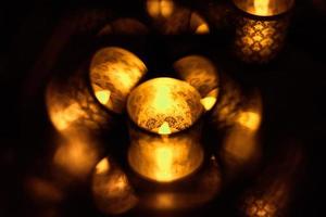 Candle in glass with a pattern illuminated photo