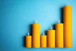 Beeswax candles on a blue background photo