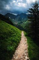 Mountain walk to a dark landscape photo