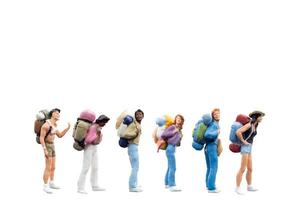 Miniature backpacker tourists isolated on a white background photo