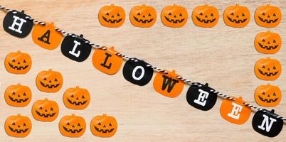 Halloween decoration, black and orange flags on a wooden background photo