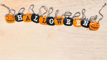 Halloween decoration, black and orange flags on a wooden background photo