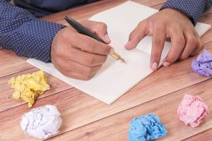 Crumpled paper ball and notepad photo