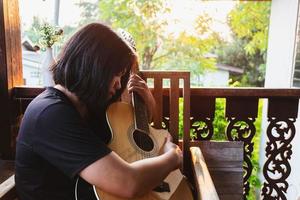 Woman playing a guitar photo