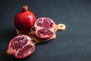 Close-up of pomegranate fruit on black photo