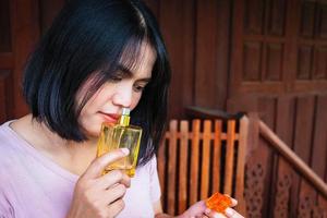 Close-up of woman smelling perfume photo