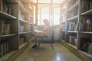 Boy reading in sunlight photo