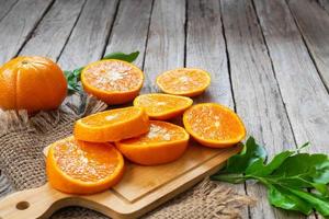 Sliced oranges on wood photo