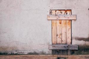 Brown wooden door on a white wall photo