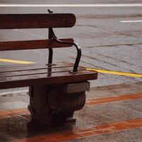 Wooden bench on the street in a city photo