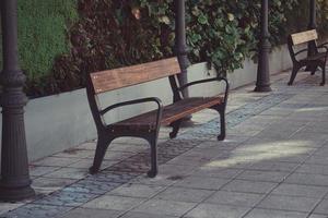Wooden bench on the street in a city photo