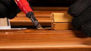 A hand eliminating chip defects, wooden door restoration photo