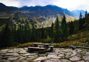 Picnic bench in the mountains photo