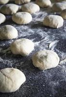 Raw buns sprinkled with flour photo