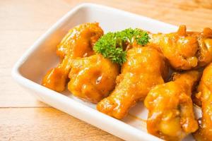 Grilled buffalo wings in white plate photo