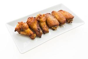 Grilled chicken wing in white plate photo