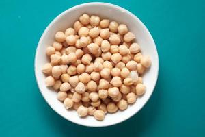 Chick peas in a bowl on blue background photo