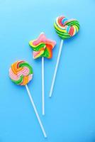 Colorful lollipops on blue background photo