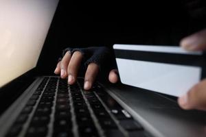 Hacker hand stealing data from credit card photo