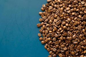 Coffee beans on blue background with copy space photo