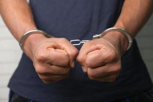 Close up of man in handcuffs photo