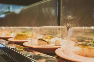 Sushi tray on conveyor belt photo